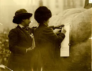 Two suffragettes signing a petition Two suffragettes signing a petition