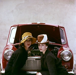 <b class=qtipBold><figcaption>Tatler cover photoshoot</figcaption></b><br>Tatler cover photoshoot focusing on hats and the Motor Show -- two female models posing in front of a red Mini car. A variant shot from this particular photoshoot was used for the cover of The Tatler issue for 21 October 1959 (see image 11064837). 1959<br><em>© The Colin Sherborne Collection/Mary Evans Picture Library</em> Tatler cover photoshoot