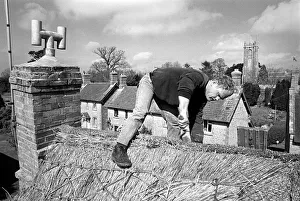 Thatcher working on Somerset cottage -1 Thatcher working on Somerset cottage -1