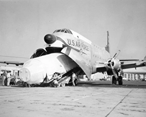 A Thor missile is loaded into a Douglas C-124 Globemaster II A Thor missile is loaded into a Douglas C-124 Globemaster II
