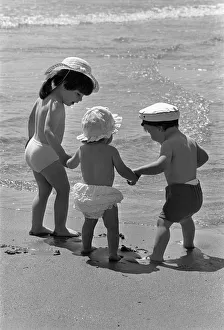 Three tots on beach, Tenby, Pembrokeshire, Wales Three tots on beach, Tenby, Pembrokeshire, Wales