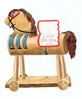 Toy horse on wheels on a cutout New Year card Toy horse on wheels on a cutout New Year card