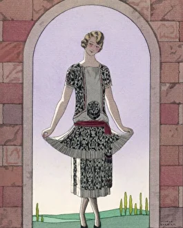 <b class=qtipBold><figcaption>Tunic Dress/Worth 1924</figcaption></b><br>Tunic dress by Worth in an ornate monochrome print with red detailing, plain central panel with motif, sash tied at the hips & a double skirt with a plain pleated flounce.<br><em>© Mary Evans Picture Library</em> Tunic Dress/Worth 1924