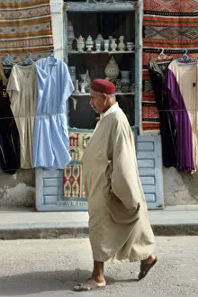 A Tunisian man wearing a djelleba and a chechia hat