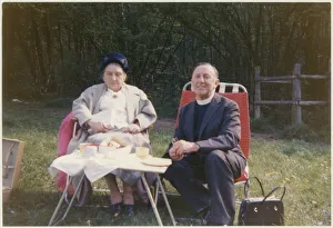 Vicar and elderly parishioner having a picnic tea Vicar and elderly parishioner having a picnic tea