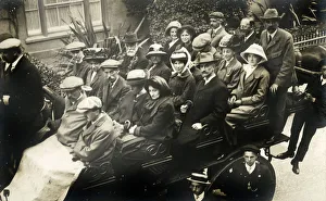 Visitors/Holidaymakers (wrapped-up warm!) head off on a British sightseeing tour in a Visitors/Holidaymakers (wrapped-up warm!) head off on a British sightseeing tour in a