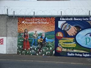 Wall mural of Tommy Sands with Moya & Fionan at Belfast