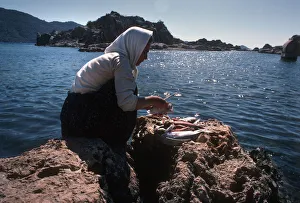 Woman cleaning fish, Turkey Woman cleaning fish, Turkey