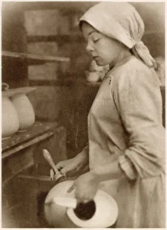 Woman at the cleaning stage of pottery-making. Date: 1913 Woman at the cleaning stage of pottery-making. Date: 1913