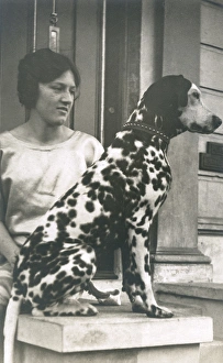 Woman with Dalmatian outside a house Woman with Dalmatian outside a house