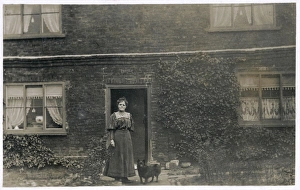Woman and dog outside a farnhouse