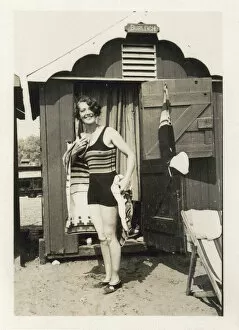 Woman drying herself after a dip in the sea outside her hut