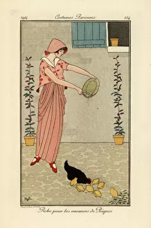 Serge Collection: Woman feeding chickens in dress for the Easter holiday