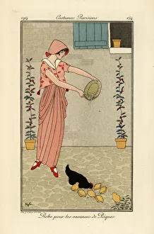 Woman feeding chickens in dress for the Easter holiday Woman feeding chickens in dress for the Easter holiday