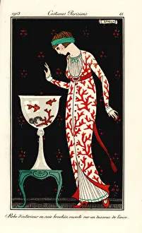Woman in house gown of coral-print silk over a linen Woman in house gown of coral-print silk over a linen