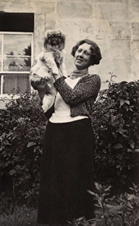 Woman with Pekingese dog in a garden Woman with Pekingese dog in a garden