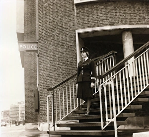 Woman police officer leaving police station, London Woman police officer leaving police station, London