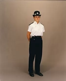 Woman police officer in white shirt and bowler hat, London