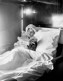 Woman reading in an Electric-lighted sleeper berth Woman reading in an Electric-lighted sleeper berth