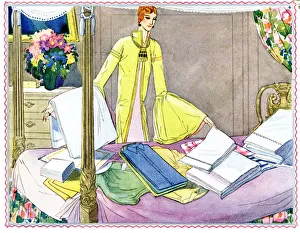 Woman sorting out laundry on four poster bed Woman sorting out laundry on four poster bed