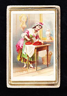 Woman using a heart-shaped iron on a Valentine card Woman using a heart-shaped iron on a Valentine card