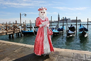 Woman wearing Venice Carnival Costume and Gondolas Woman wearing Venice Carnival Costume and Gondolas
