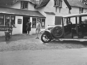 Two women outside a village shop with their car Two women outside a village shop with their car