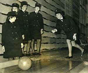 Women police officers at a bowling alley Women police officers at a bowling alley