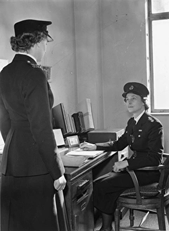 Two women police officers at work in a station, London Two women police officers at work in a station, London