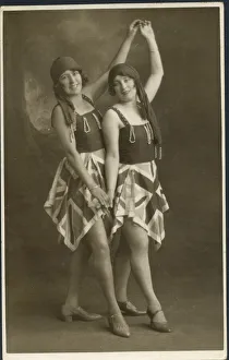 Two women pose for a photograph in identical fancy dress costumes Two women pose for a photograph in identical fancy dress costumes