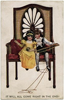 WW1 - Two little seated children playing with a ball of wool WW1 - Two little seated children playing with a ball of wool