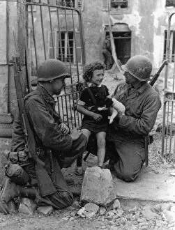 Comfort Gallery: WW2 - US Troops comfort a distressed child and puppy