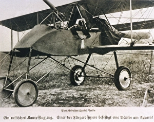 <b class=qtipBold><figcaption>Wwi/Russian Plane/1914</figcaption></b><br>A Russian officer attaches a bomb to the side of his aircraft<br><em>© Mary Evans Picture Library/WEIMA</em> Wwi/Russian Plane/1914