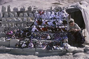 Bored Gallery: A young girl and her doll and trinket souvenir stall, Goreme