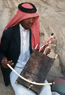 A young Jordanian man plays a rababah A young Jordanian man plays a rababah