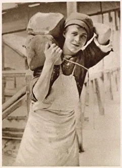 A young lad carrying the clay. Date: 1913 A young lad carrying the clay. Date: 1913