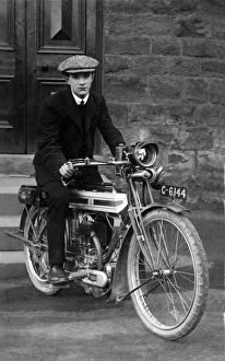 Young man on a 1910/14 Triumph motorcycle Young man on a 1910/14 Triumph motorcycle