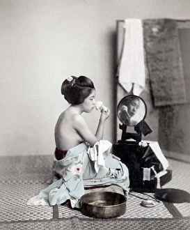 Orient Gallery: Young woman putting on makeup at a mirror, Japan, c.1880 s