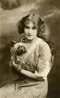 Young woman with small dog in studio portrait Young woman with small dog in studio portrait