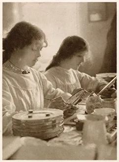 Young women painting plates, this would of been done in several stages. Date: 1913 Young women painting plates, this would of been done in several stages. Date: 1913