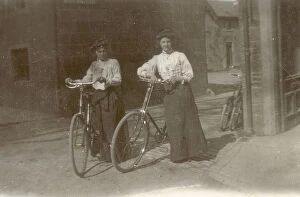 Two young women pose proudly with their bicycles at Moffat in Dumfriesshire