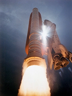<b class=qtipBold><figcaption>STS-43 Launch</figcaption></b><br>The Space Shuttle Atlantis streaks skyward as sunlight pierces through the gap between the orbiter and ET assembly. Atlantis lifted off on the 42nd space shuttle flight at 11:02 a.m. EDT on August 2, 1991 carrying a crew of five and TDRS-E. A remote camera at the 275-foot level of the Fixed Surface Structure took this picture.<br><em>© NASA</em> STS-43 Launch