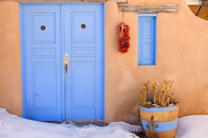 Adobe style house - simple beige coloured house in adobe style with a bright blue Adobe style house - simple beige coloured house in adobe style with a bright blue