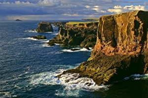 Basalt cliffs - rugged basalt cliffs of Eshaness in last evening light Basalt cliffs - rugged basalt cliffs of Eshaness in last evening light