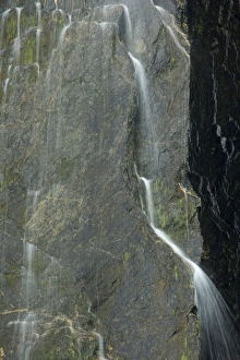 Cascades - water falling down nearly vertical cliff creating many tiny cascades Cascades - water falling down nearly vertical cliff creating many tiny cascades