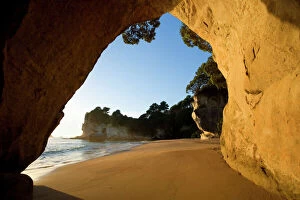 Erosion Gallery: Cathedral Cove - beach at Cathedral Cove seen through a natural rock arch in early morning light