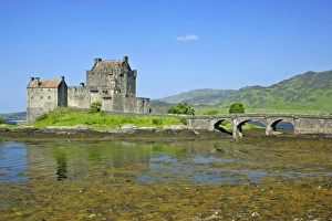 Eilean Donan Castle - view of castle located in Loch Duich at low tide on a sunny day Eilean Donan Castle - view of castle located in Loch Duich at low tide on a sunny day