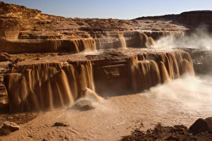 Grand Falls - raging muddy falls of the Little Colorado River during snowmelt Grand Falls - raging muddy falls of the Little Colorado River during snowmelt