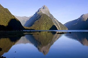 Milford Sound - landmark Mitre Peak and surrounding mountains reflected in the calm Milford Sound - landmark Mitre Peak and surrounding mountains reflected in the calm