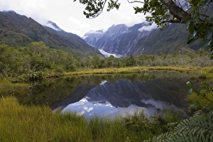 New Zealand - Franz Josef glacier reflected in Peters Pool New Zealand - Franz Josef glacier reflected in Peters Pool